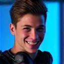 Portrait of Alex, a gamer with a mobility challenge, smiling confidently.