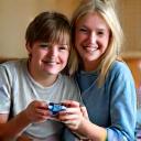 Portrait of Sarah and her son Ben, an autistic child, smiling together while holding a simple, tactile gaming controller designed for accessibility.